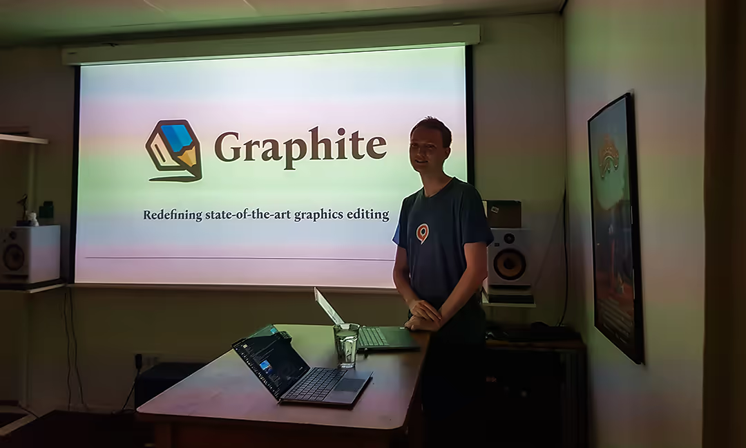 Keavon presents in front of a projector screen at Blender's offices